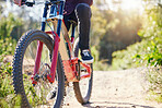 Nature, cycling and feet with a bicycle for travel, fitness or training on the mountain. Closeup, morning and legs of a person with a bike on a path for a triathlon, exercise or sports adventure