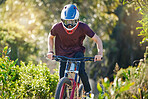Fitness, nature and man cycling in training for a race competition on biking trail or woods. Action, sports or fast cyclist athlete riding bicycle at speed for cardio exercise, fitness or workout
