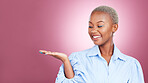 Palm, hand and a woman in studio for advertising, marketing or announcement and launch. Happy face of an excited African person on a pink background for choice, presentation or promotion mockup space