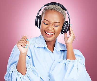Buy stock photo Headphones, dance and happy black woman in studio with music, radio or streaming subscription on pink background. Podcast, earphones or African lady model dancing to album track or feel good playlist
