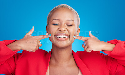 Buy stock photo Happy, pointing and young black woman with cheek for smile in a studio with an excited or positive attitude. Beauty, confident and African female model with cosmetic face isolated by blue background.