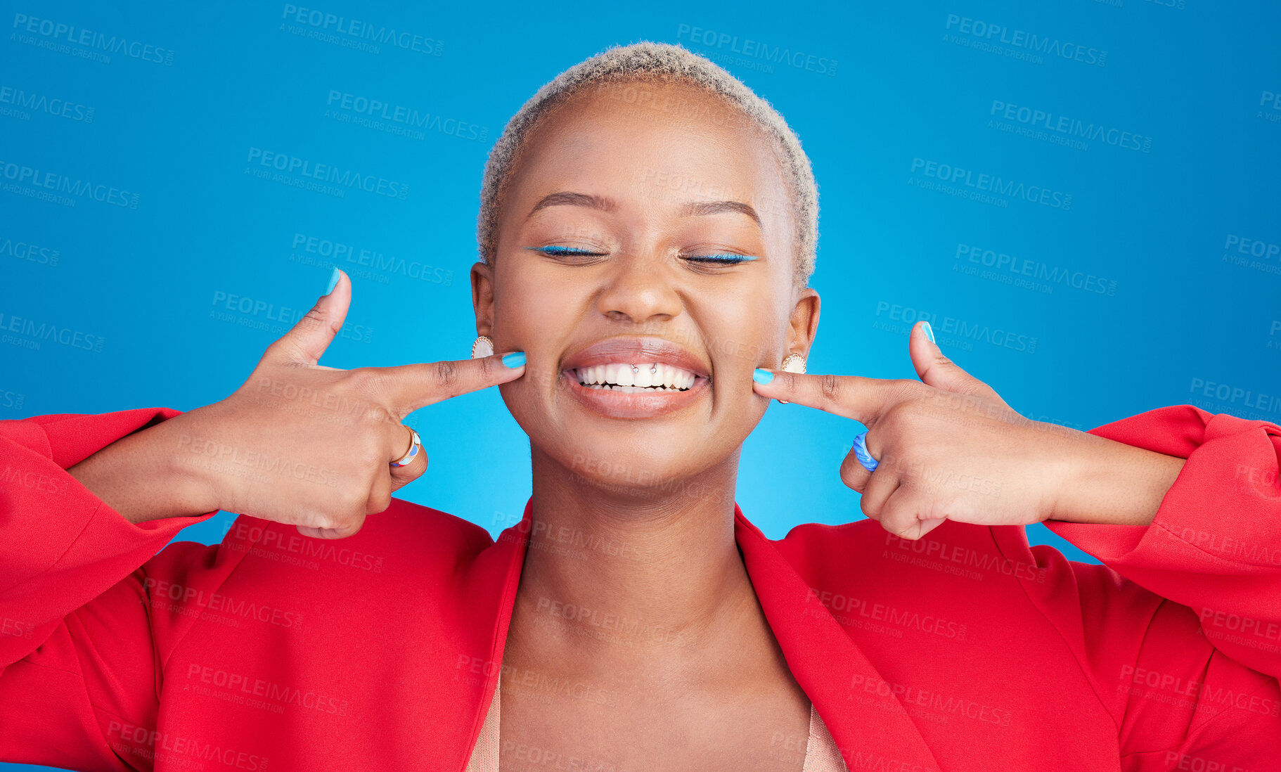 Buy stock photo Happy, pointing and young black woman with cheek for smile in a studio with an excited or positive attitude. Beauty, confident and African female model with cosmetic face isolated by blue background.