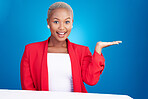 Portrait, black woman and hand holding in studio for promo, announcement or coming soon deal on blue background. Happy, face and African lady model show mockup, space or prize, giveaway and deal info