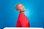 Cosmetics, laugh and young black woman in a studio with makeup, glamour and face routine. Happy, smile and African female model with a cosmetology facial treatment isolated by a blue background.