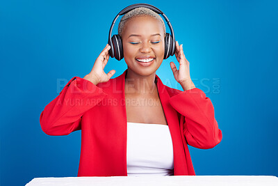 Buy stock photo Music, headphones and black woman dance in studio celebration with news, feedback or promo on blue background. Freedom, happy and African model dancing to earphones radio, podcast or audio streaming
