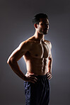 Muscle, strong and studio man with fitness challenge results, bodybuilder progress and body transformation training. Dark shadow, exercise and confident sports athlete thinking on grey background