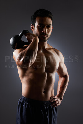 Buy stock photo Training focus, portrait and man with kettlebell workout, muscle building and fitness results, motivation or weightlifting. Gym equipment, bodybuilder focus and dark studio athlete on grey background