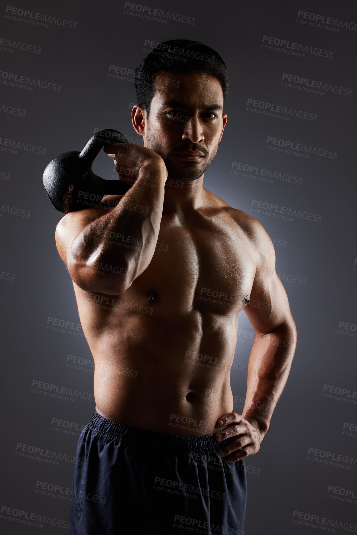 Buy stock photo Training focus, portrait and man with kettlebell workout, muscle building and fitness results, motivation or weightlifting. Gym equipment, bodybuilder focus and dark studio athlete on grey background