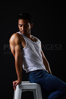 Buy stock photo Beauty with sexy, muscular man on chair in studio and fitness inspiration, aesthetic and sensual fashion. Erotic art, sexual body and male model sitting on black background, thinking in dark lighting