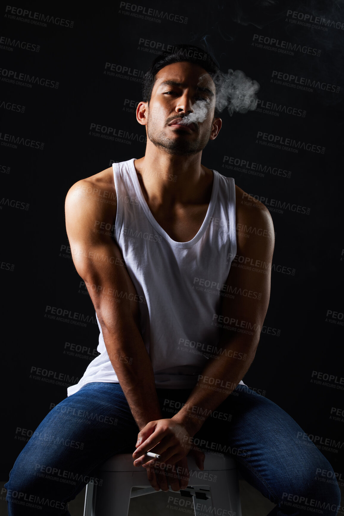 Buy stock photo Smoking portrait, sexy man and chair in studio in fitness, beauty aesthetic and strong sensual fashion. Art, body and male model with muscle, cigarette and jeans on black background in dark lighting.