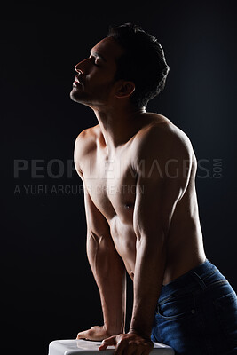 Buy stock photo Topless, sexy and man in dark studio for fitness inspiration, beauty aesthetic or casual fashion. Strong body and shirtless male model with muscle, black background and healthy art with lighting