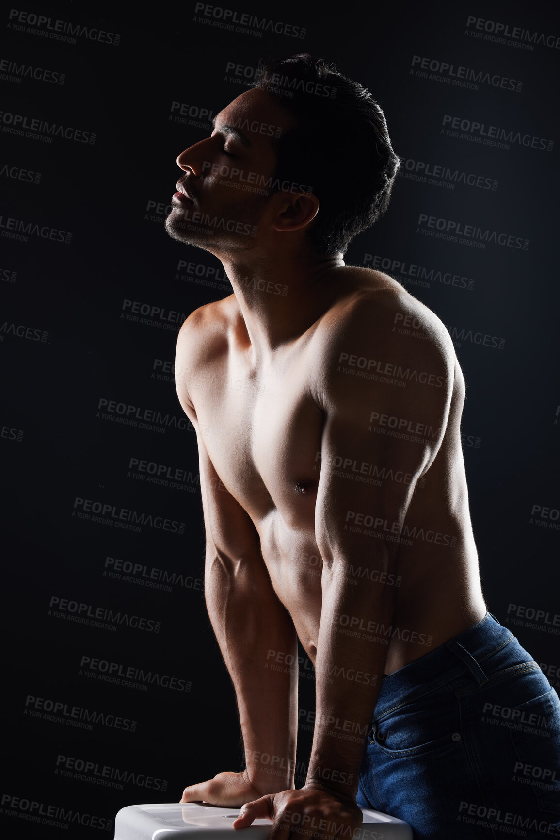 Buy stock photo Topless, sexy and man in dark studio for fitness inspiration, beauty aesthetic or casual fashion. Strong body and shirtless male model with muscle, black background and healthy art with lighting