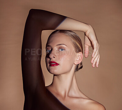 Buy stock photo Spotlight, portrait or woman with lipstick, beauty or creative aesthetic with light on studio background. Glow, face or model with dark shadow or art style for skincare, makeup or facial cosmetics