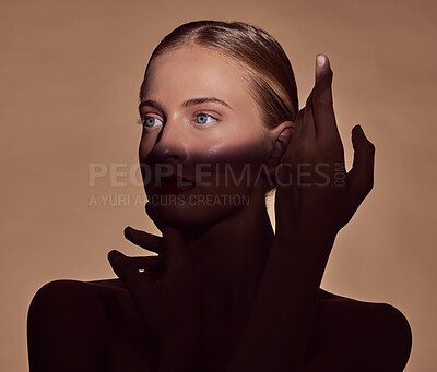 Buy stock photo Spotlight, face or woman in shadow with beauty and creative aesthetic in studio background. Light on eyes, person or elegant model with dark side, art or style thinking of skincare, glow or cosmetics