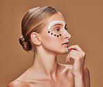 Face paint, woman and profile with skincare, dermatology and creative art in studio. Beauty, thinking and makeup with unique artwork and cosmetics with wellness of model with brown background