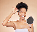 Woman, tweezers and mirror for eyebrow in studio, beauty or thinking for results, reflection or idea by background. African girl, model and smile for facial hair removal, inspection or transformation