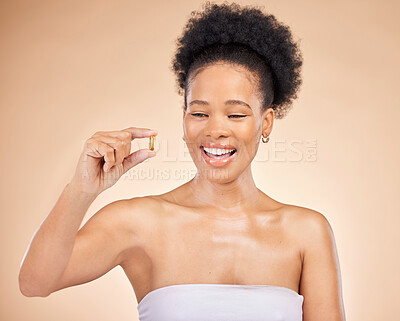 Buy stock photo Skincare, smile of black woman and fish oil for beauty isolated on a brown background in studio. Happy, natural cosmetics and omega 3 supplements, biotin or vitamin pills of African model for health