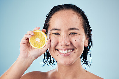 Buy stock photo Portrait, smile or happy woman with orange for skincare or beauty in studio on blue background. Results, dermatology shine or Asian person with natural fruits, vitamin c or glowing face for wellness