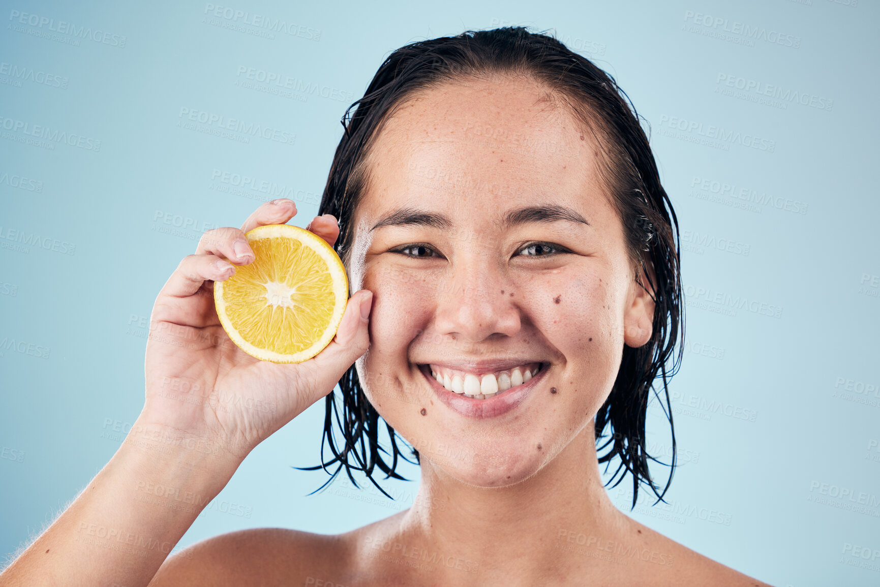 Buy stock photo Portrait, smile or happy woman with orange for skincare or beauty in studio on blue background. Results, dermatology shine or Asian person with natural fruits, vitamin c or glowing face for wellness