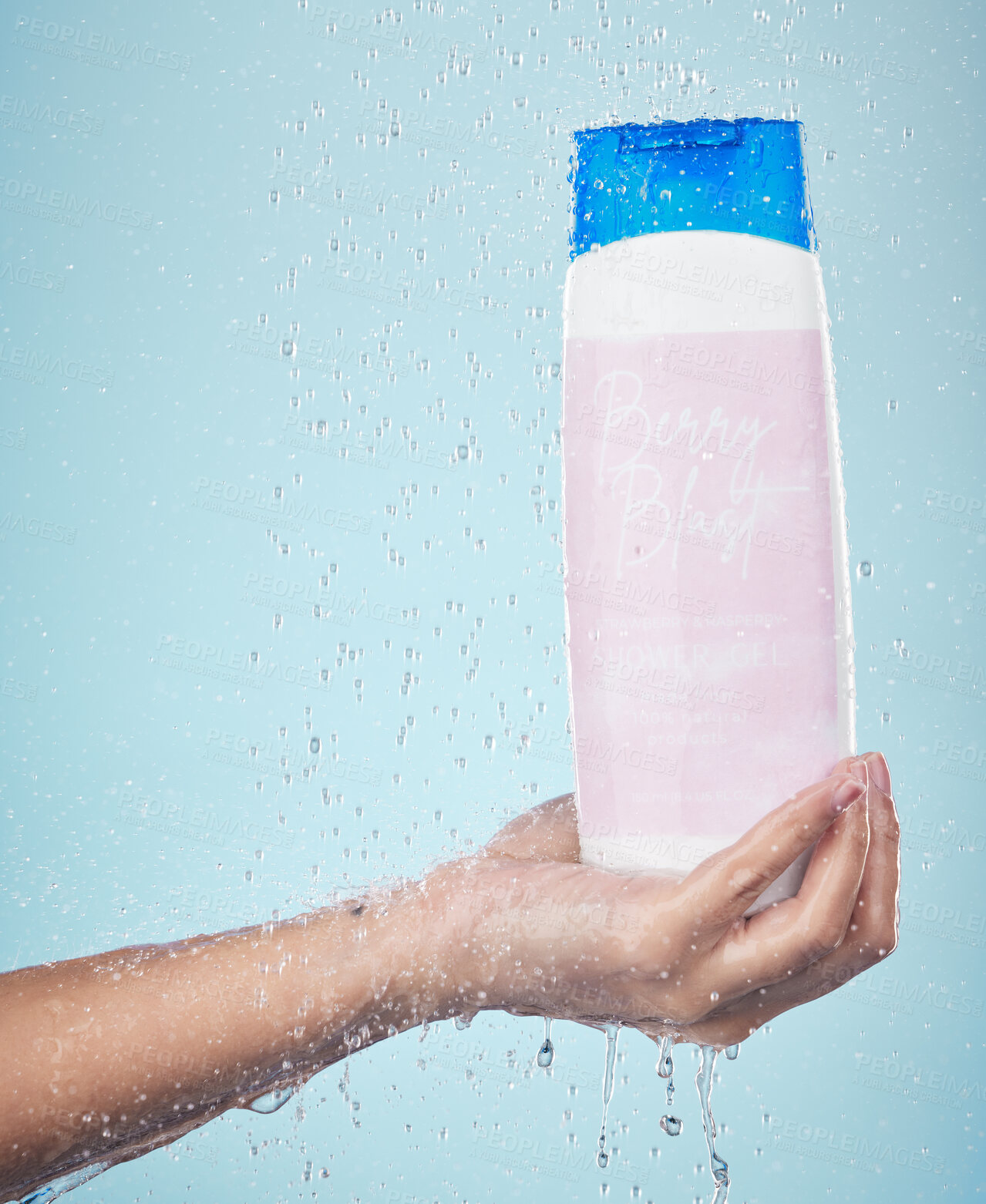 Buy stock photo Person, hand and shower gel with product in hygiene, washing or cleanse against a blue studio background. Closeup of model holding skin cosmetics, soap or body care with water drops in bathroom
