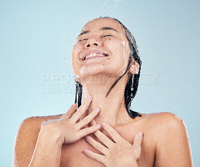 Buy stock photo Skincare, shower and happy woman cleaning in studio isolated on a blue background. Water splash, hygiene and model smile, washing and bathing in wellness, healthy skin beauty of body in bathroom.