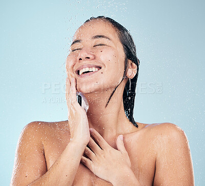 Buy stock photo Skincare, shower and happy woman cleaning in studio isolated on a blue background. Water splash, hygiene and model smile, washing and bathing in wellness, healthy skin beauty of body in bathroom.