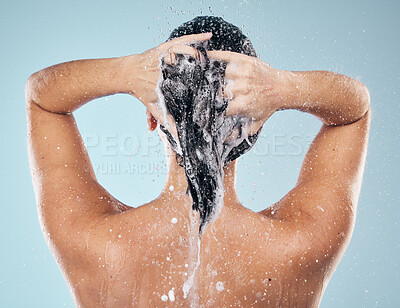 Buy stock photo Shower, shampoo or woman cleaning hair for wellness or healthy head in studio on blue background. Cosmetics, beauty model or back of wet person washing or grooming for natural hygiene to relax