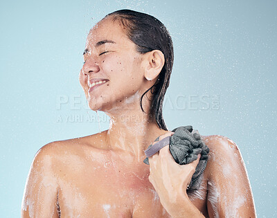 Buy stock photo Clean, woman and shower with water, soap and sponge for healthy dermatology, skincare and blue background in studio. Person, smile and washing skin and body with foam bubbles in bathroom