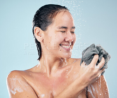 Buy stock photo Woman, shower and clean with water, soap and sponge for healthy dermatology, skincare and blue background in studio. Person, smile and washing skin, body and self care with cosmetics in bathroom