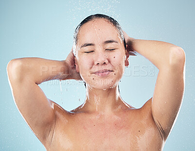 Buy stock photo Skincare, shower and woman cleaning hair in studio isolated on a blue background. Water splash, hygiene and model washing, cosmetic and bathing in wellness, healthy skin or beauty of body in bathroom