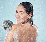 Woman, portrait and shower with water, soap and sponge for cleaning with dermatology, skincare and blue background in studio. Person, smile and washing skin and body with foam bubbles in bathroom