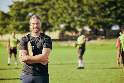 Buy stock photo Portrait, fitness and a rugby coach on a field with his team training or getting ready for match competition. Exercise, sports and strategy with a happy male trainer on grass for practice workout