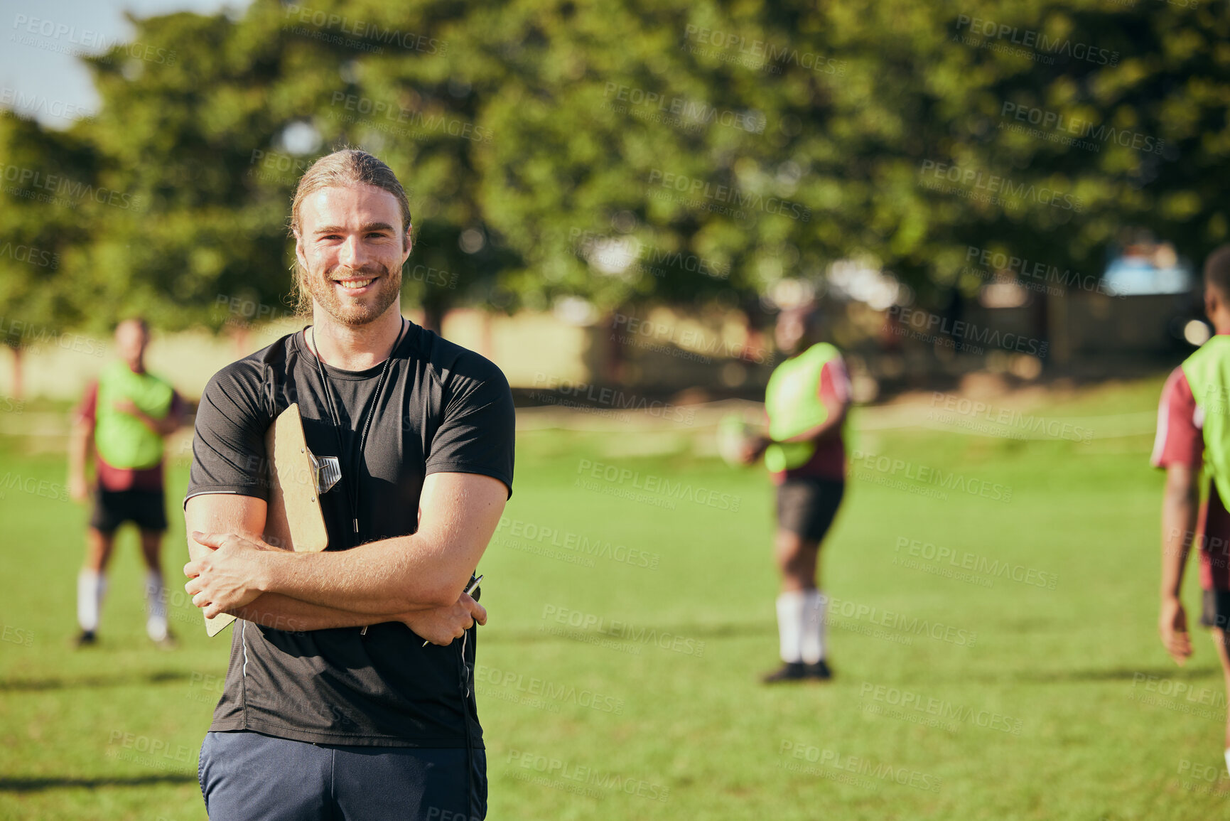 Buy stock photo Portrait, fitness and a rugby coach on a field with his team training or getting ready for match competition. Exercise, sports and strategy with a happy male trainer on grass for practice workout