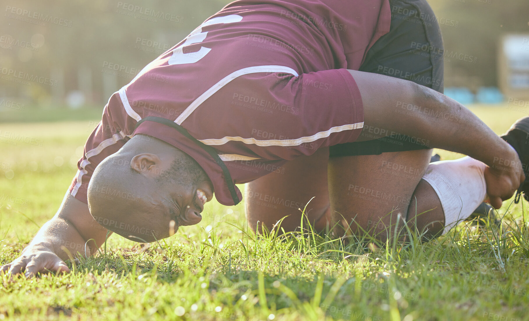 Buy stock photo Sports, field injury and a black man during soccer with an emergency in fitness or training. Grass, pain and an African football player or athlete on the ground during a game with an accident