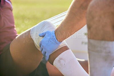 Buy stock photo First aid, sport injury bandage and hands on knee with soccer accident, fitness and massage on a field. Training, workout and physical therapy of leg pain at game with emergency from exercise 