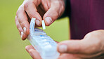 Pills, medicine box and hand closeup of a sport athlete on a soccer field with tablet and drugs for health. Supplements, container and outdoor with a man holding wellness and medication inventory