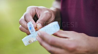 Buy stock photo Pill box, medicine and hand closeup of a sport athlete on a soccer field with tablet and drugs for health. Supplements, container and outdoor with a man holding wellness and medication for pain