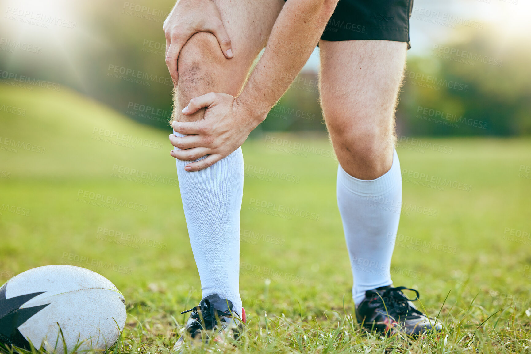 Buy stock photo Knee pain, rugby legs and sports person tired, fatigue and sore training accident, match game or challenge on grass field. Body agony, athlete anatomy or closeup of player with medical emergency risk