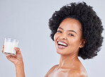 Woman, portrait and milk glass in studio for healthy diet, detox or calcium on white background. Happy african model, dairy drink or smoothie of vanilla milkshake for nutrition, weight loss or beauty
