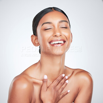 Buy stock photo Face, beauty and smile with a woman laughing for health or wellness in studio on white background. Skincare, funny and cosmetics with a young model feeling happy or satisfaction about natural skin