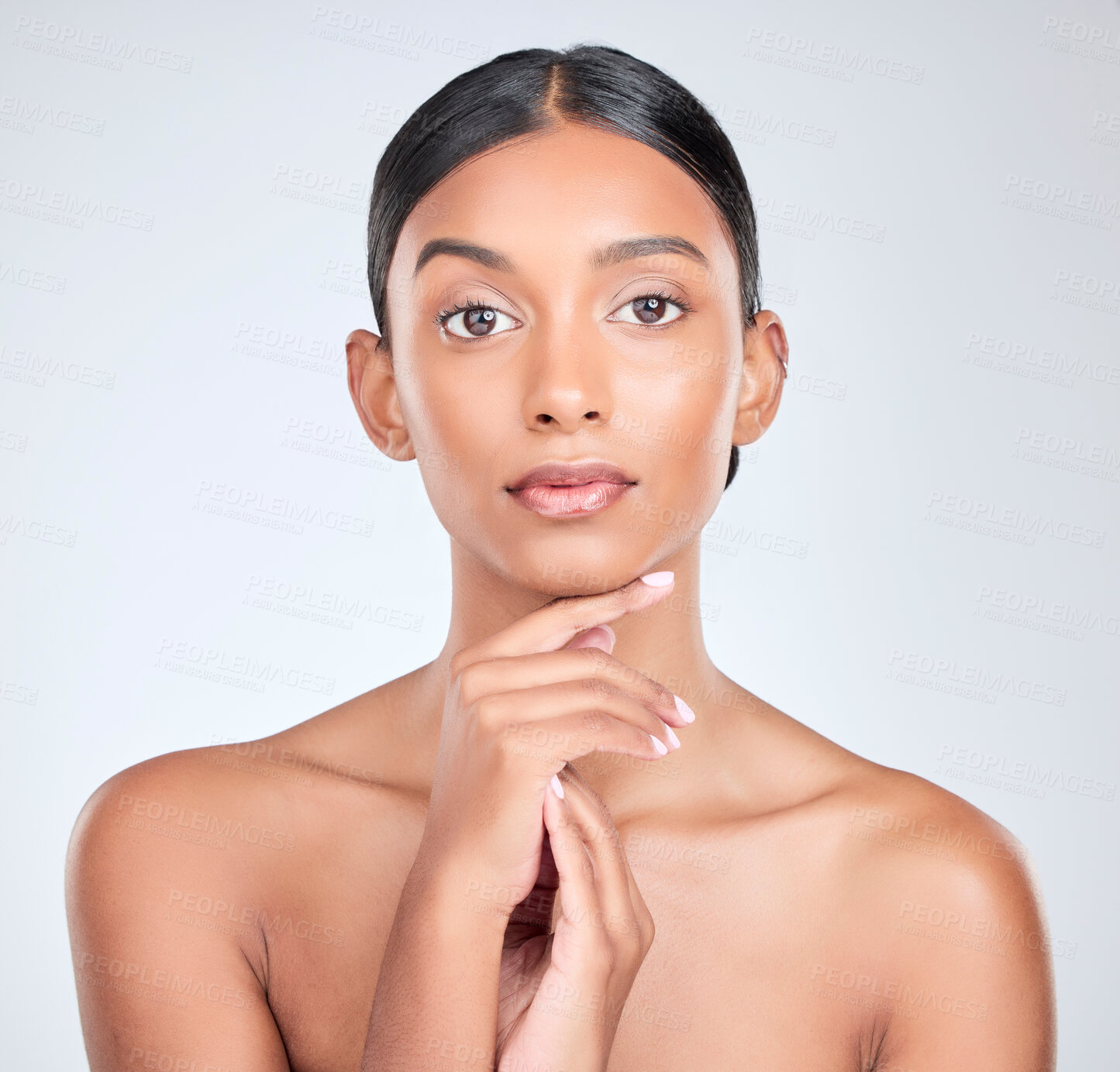 Buy stock photo Studio portrait of Indian woman for skincare, beauty and cosmetics on white background for salon aesthetic. Dermatology, spa and serious face of isolated person for wellness, glamour and facial glow