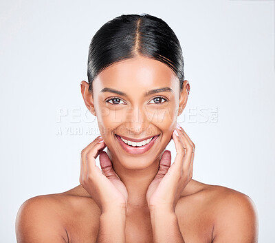 Buy stock photo Portrait, natural beauty and woman in a studio with cosmetics, self care and clean makeup isolated on white background. Wellness, dermatology and skincare, Indian model smile with skin glow and shine