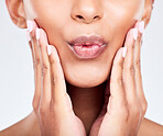 Face, hands and lips with a woman closeup in studio on a white background for beauty, skincare or natural cosmetics. Aesthetic, mouth and wellness with a young model touching her healthy skin