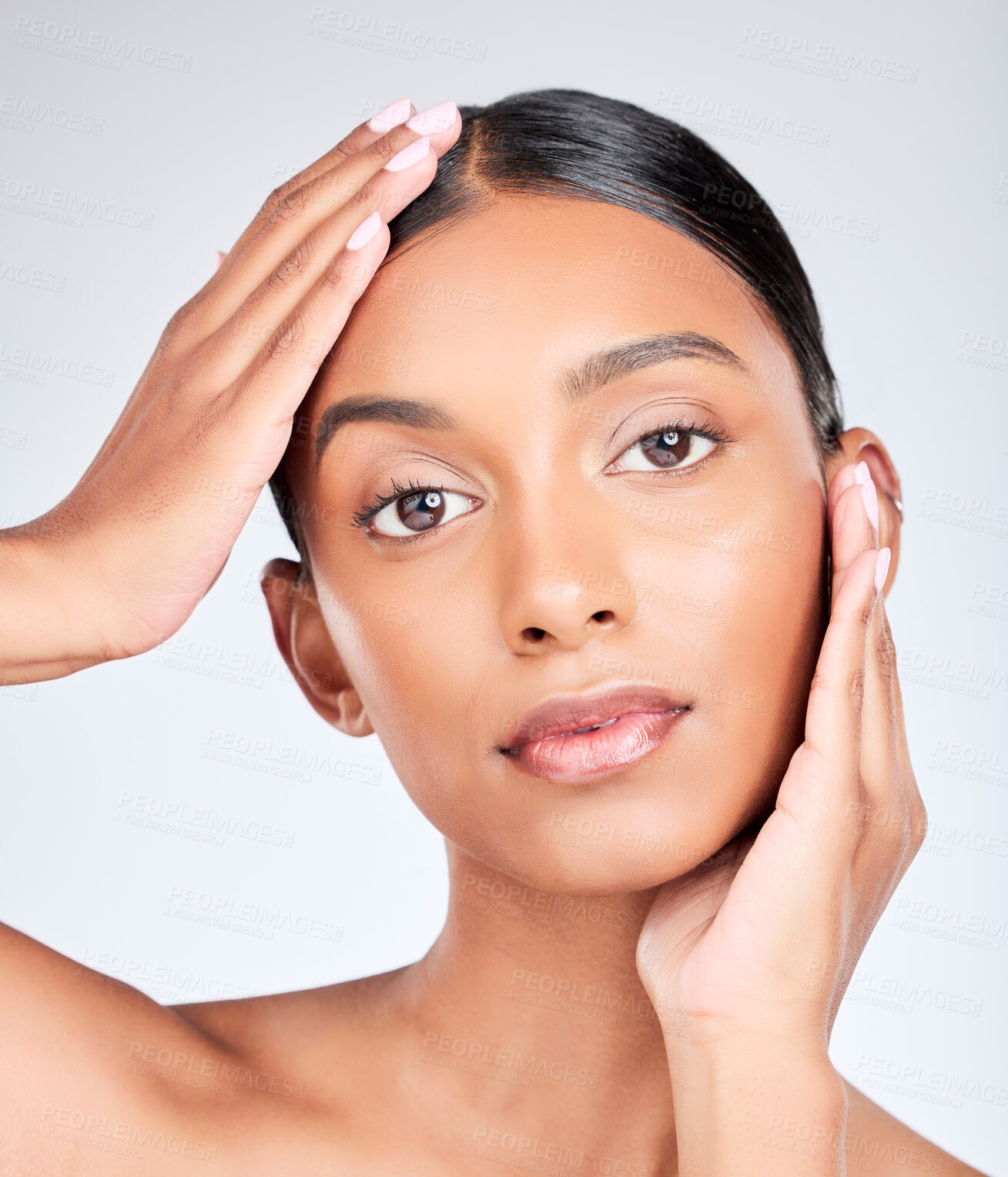 Buy stock photo Portrait of Indian woman with hands for skincare, beauty and cosmetics on white background for facial. Dermatology, spa and serious face of isolated person for wellness, self care or health in studio