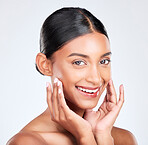 Portrait, woman and touch face in studio for clean skincare, aesthetic glow and healthy dermatology on white background. Happy young indian model, natural beauty and shine of facial cosmetic results