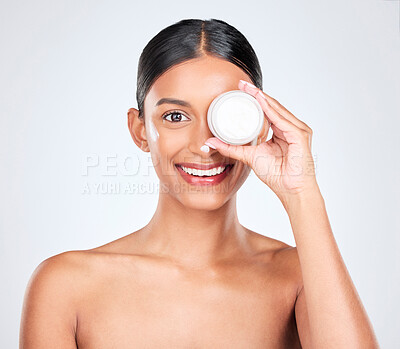 Buy stock photo Woman, cream on face and container for beauty, moisturizer and skincare isolated on white background. Cosmetics product, lotion or sunscreen with smile, facial and skin with dermatology in studio