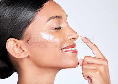 Buy stock photo Face, cream and woman with skincare, beauty and self care on a white studio background. Person, profile and model with creme, sunscreen and wellness with grooming, shine and aesthetic with lotion