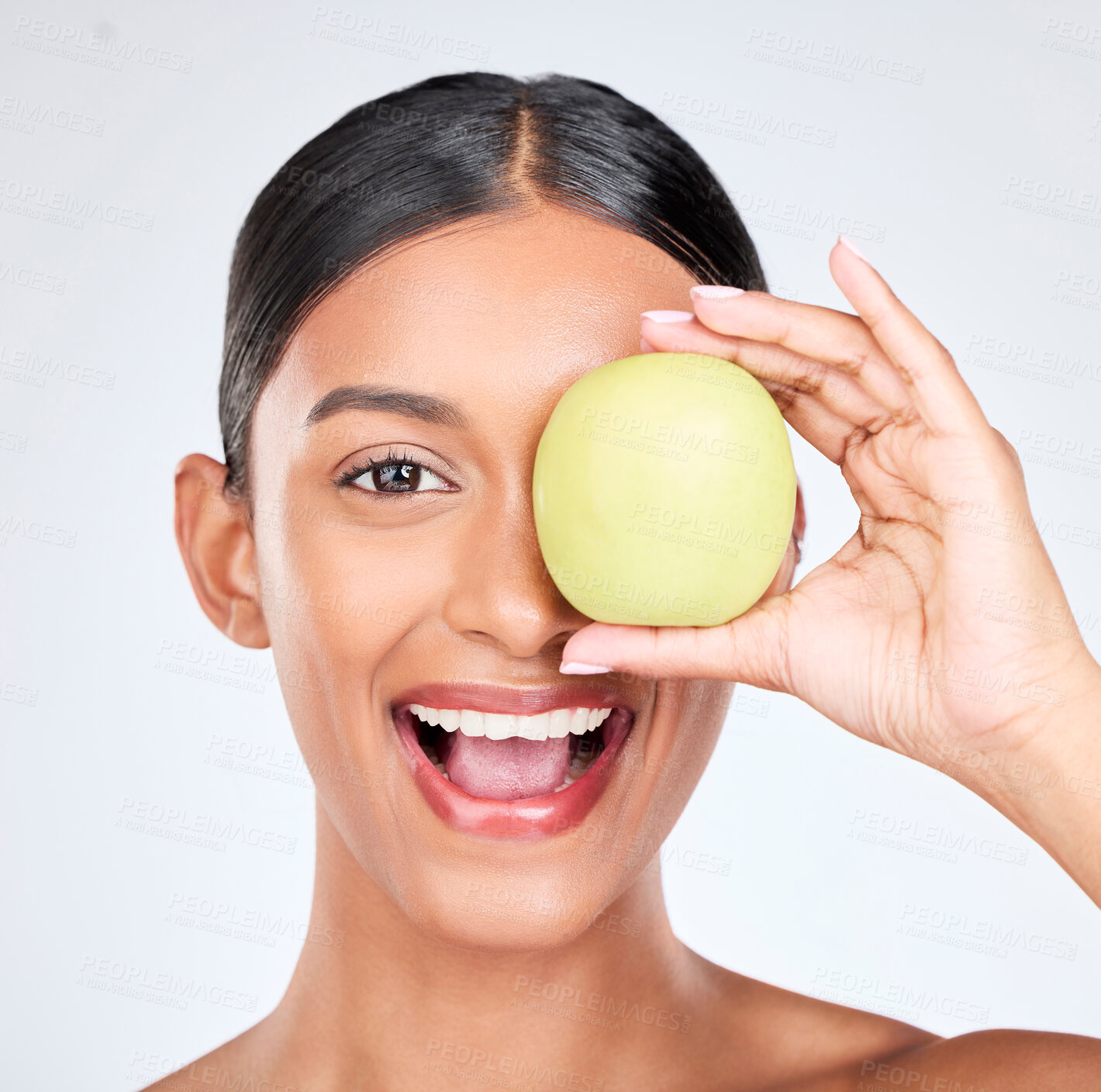 Buy stock photo Apple, portrait and skincare of woman in studio for vitamin c benefits, natural cosmetics and nutrition on white background. Face of happy indian model, healthy beauty and green fruits for vegan diet