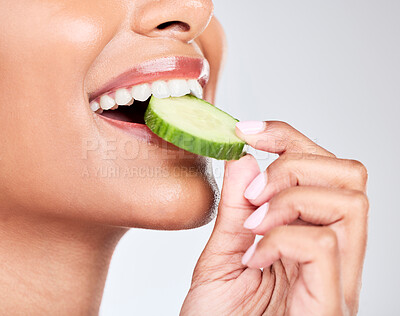 Buy stock photo Woman, mouth and eating cucumber in studio closeup for health, diet and detox by white background. Girl, model and nutrition with fruit, vegetable and vegan food for beauty, skincare and wellness