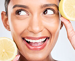 Lemon, fruit and face of Indian woman with skincare, beauty and benefits of vitamin c in eco friendly cosmetics in studio. Indian, model and thinking of dermatology with healthy and natural fruits